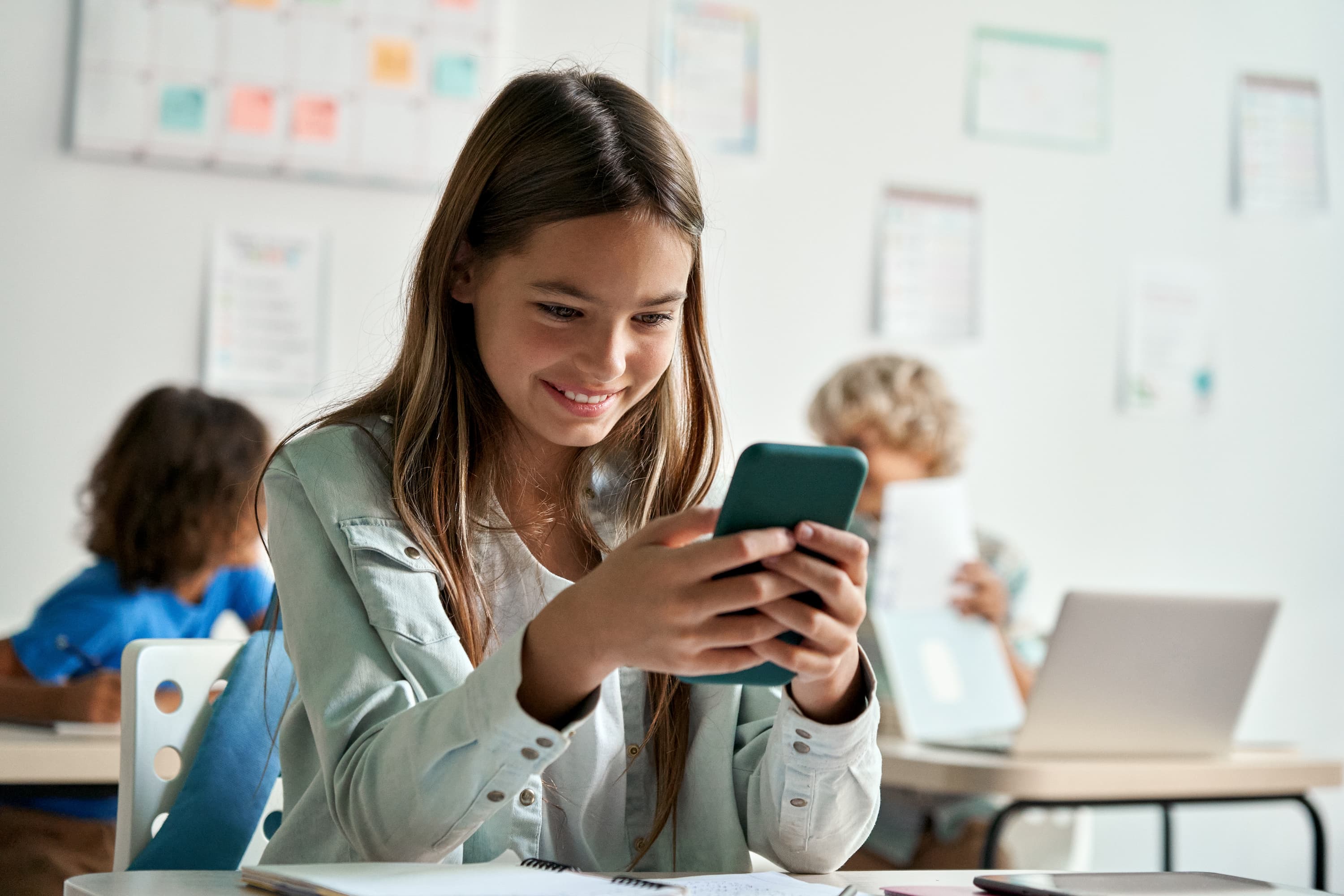 A young student using a smart phone.