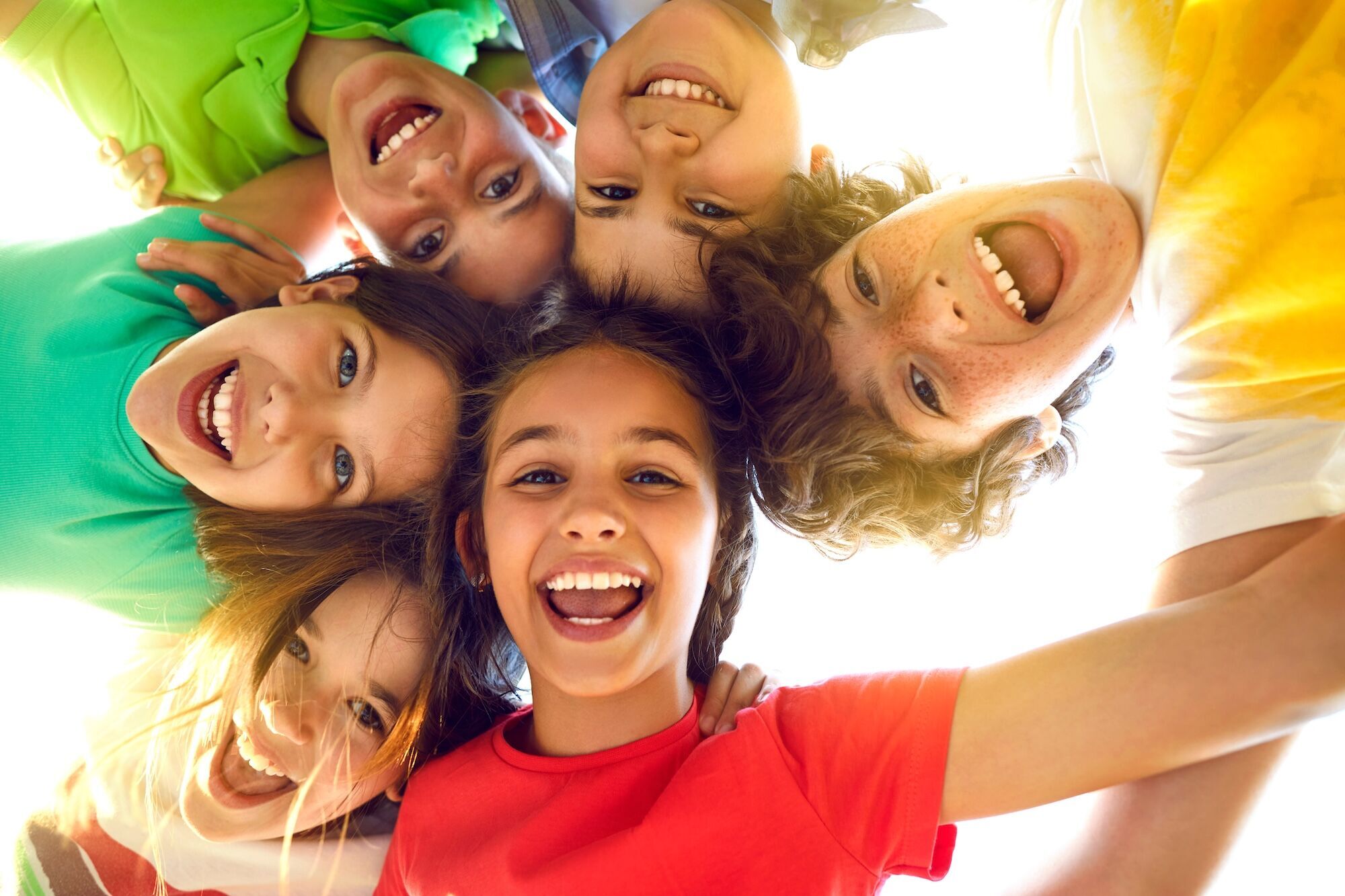 Children smiling in a circle.