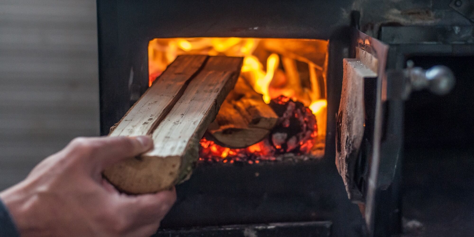 Wood going in a fireplace.