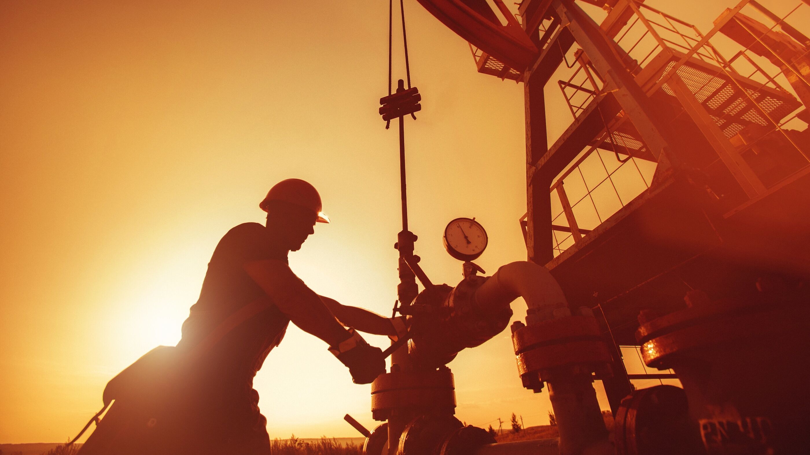 Silhouetted oil worker.
