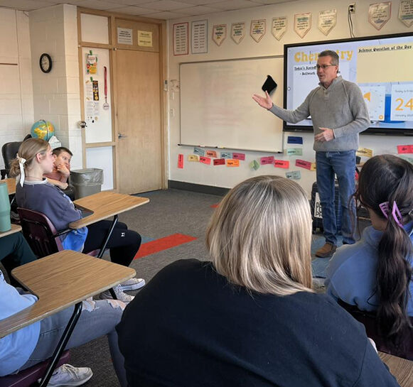 Kansas Strong teaching a room full of students.